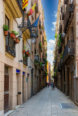 Fototapeta premium Old narrow street in Barcelona, Catalonia, Spain. Architecture and landmark of Barcelona. Cozy cityscape of Barcelona