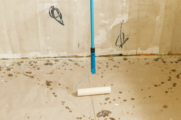 Roller brush close up with prime for plaster walls. Construction of house and home renovation...