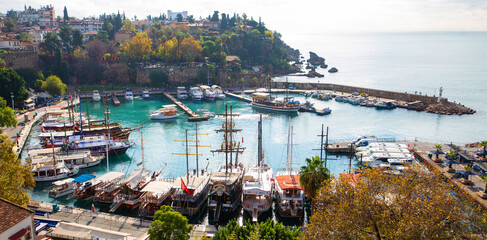 The old port of Antalya - Antalya Kaleici Yat Limani. The old town. With yachts, boats. and old buildings. View from above. Antalya, Turkiye.