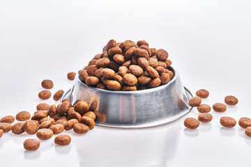  Delicious bowl of dog food balls over isolated white background