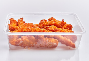  Delicious fried chicken on delivery plastic box over isolated white background