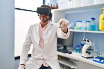 Naklejka na ściany i meble Middle age man scientist using virtual reality glasses at laboratory
