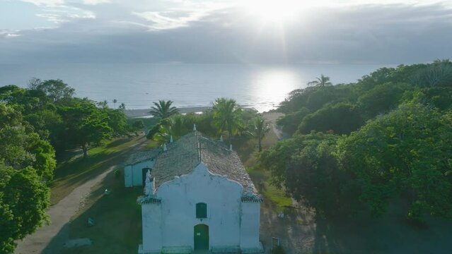 Aerial Drone View of famous beach town Trancoso in Bahia Brazil flying over Quadrado and Church towards the Ocean