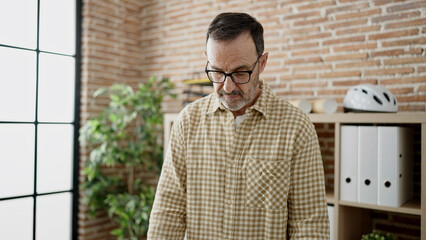Fototapeta premium Middle age man business worker standing with serious expression at street