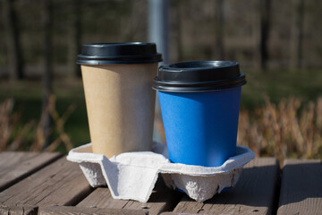 Paper cups of coffee on the street. Mockup of a cardboard cup of coffee. A mockup for a Takeaway...