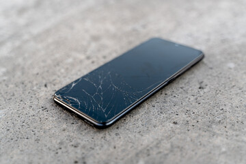 cell phone with broken screen on the floor - sideways crash