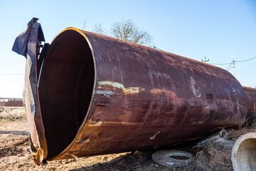 Old rusty water tower lying on the ground