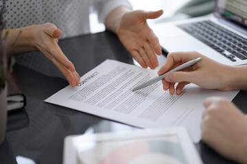 Obraz premium Businesswoman lawyer pointing into contract special points admitting something for colleague or client at meeting. Business people teamwork and partnership