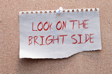 Look on the bright side advice or reminder - sticky note on a clipboard with a cup of tea