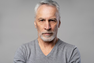 Fototapeta premium Headshot of confident successful serious senior man 60 years old, retired pensioner isolated on grey