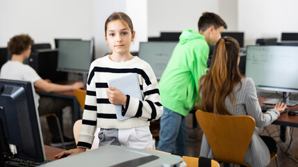Fototapeta premium Portrait of schoolgirl girl in a computer class at school