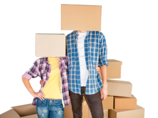 Happy young couple with cardboard boxes on the heads