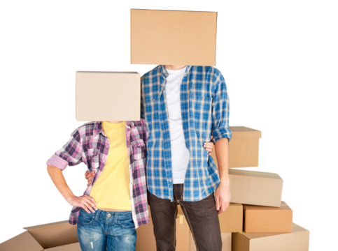 Happy young couple with cardboard boxes on the heads