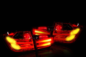 Car tail lights separate from white background.