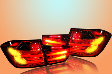 Car tail lights separate from white background.