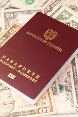 A Colombian passport on American bills of different denominations. International ID on dollars.