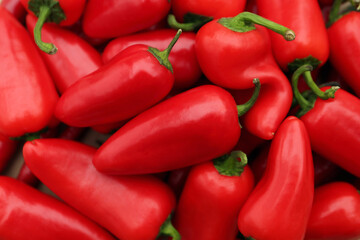 Red hot chili peppers as background, top view