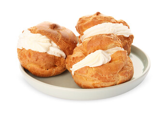 Delicious profiteroles with cream filling on white background