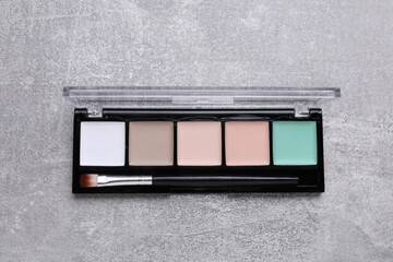 Contouring palette on light gray background, top view. Professional cosmetic product