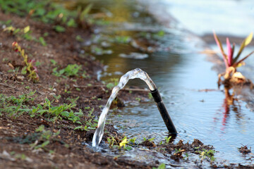 salvador, bahia, brazil - april 27, 2023: water pipe leaking in the street, featuring a potaval water discharge.