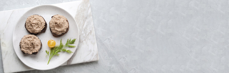 Slices of bread with delicious pate served on white marble table, top view. Banner design with space for text