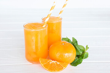 Orange smoothies yellow colorful fruit juice milkshake blend beverage healthy high protein the taste yummy In glass,drink to lose weight drink episode morning on white gray background.