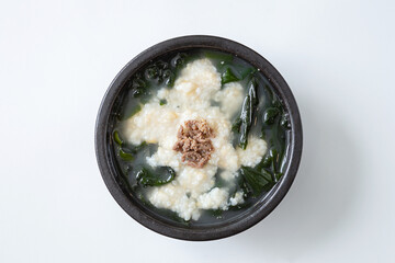 White porridge with seaweed in a bowl