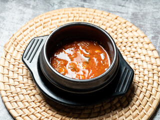 Soybean paste stew in an earthenware bowl, Korean food	
