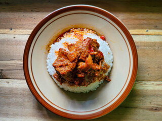 Rendang is an Indonesian West Sumatra Minangkabau spicy meat (commonly beef) that slow cooked in coconut milk and mixed spices, served during festive events like wedding, Eid Al Fitr and Eid Al Adha
