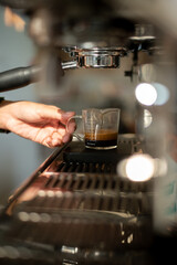 Fototapeta na wymiar A coffee machine with espresso pouring into it