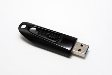 A black USB flash drive or thumb drive isolated in white with copy space.