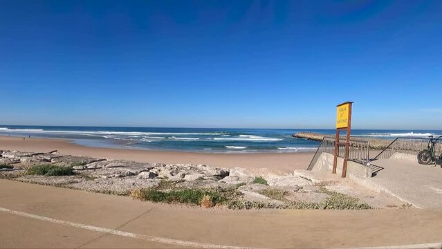 Seawall along the Costa da Caparica beach, providing protection from the waves and creating a scenic view of the ocean