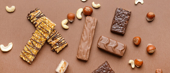 Tasty chocolate nut bars on brown background