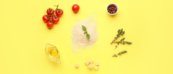 Raw ingredients for risotto on yellow background