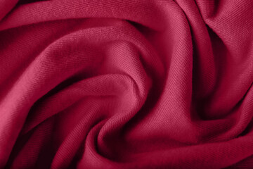 Fototapeta na wymiar Crumpled knitted viva magenta fabric, closeup