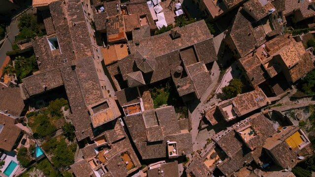 Traditional stone houses and red rooftops at Fornalutx Port de Soller mountain village near Puig Major, Palma de Mallorca. Scenic Majorca Island nature landscape aerial drone footage. Cinematic 4K UHD