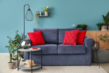 Interior of living room with sofa, table and houseplants