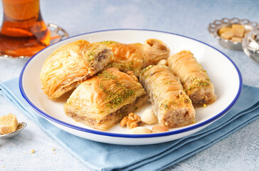 Plate with tasty baklava on light background, closeup