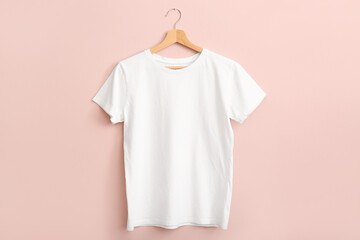 White t-shirt hanging on pink wall - obrazy, fototapety, plakaty