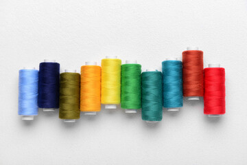 Set of colorful sewing threads on light background