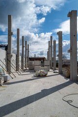 concrete pillars for a factory building are erected on a construction site