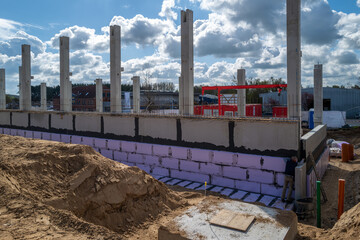 concrete pillars for a factory building are erected on a construction site