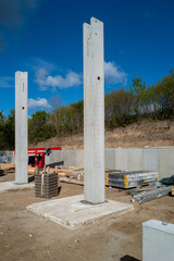 Fototapeta na wymiar concrete pillars for a factory building are erected on a construction site