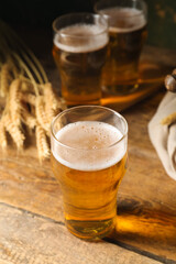 Glass of cold beer on wooden background