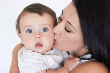 Happy, kiss and care with mother with baby for bonding, affectionate and growth. Happiness, love and family with face of woman and kissing young child on cheek for cute, sweet and kindness