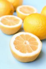Composition with fresh lemons on blue background