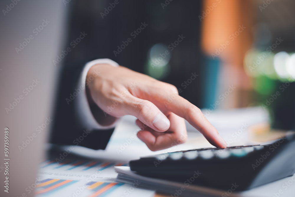 Poster Businessman using a calculator to calculate numbers ,profit and loss statement review of company performance, cost analysis ,financial paperwork ,account checking ,chart analysis and statistical data