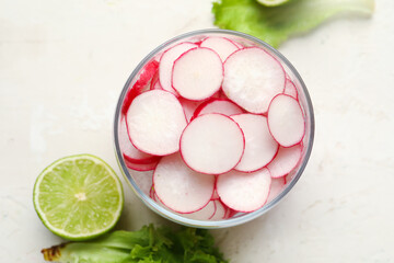 Bowl with fresh slices of radish on white background