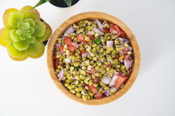 Sprouting green gram bean Indian salad with Onion, coriander leaf , green chili and tomatoes. Indian sprouting gram bean salad with isolated background.