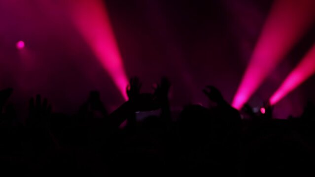 Red Lights and Modern Rhythms: DJ Performs High-Energy Music in Front of Fans on a Dynamic Stage Setting